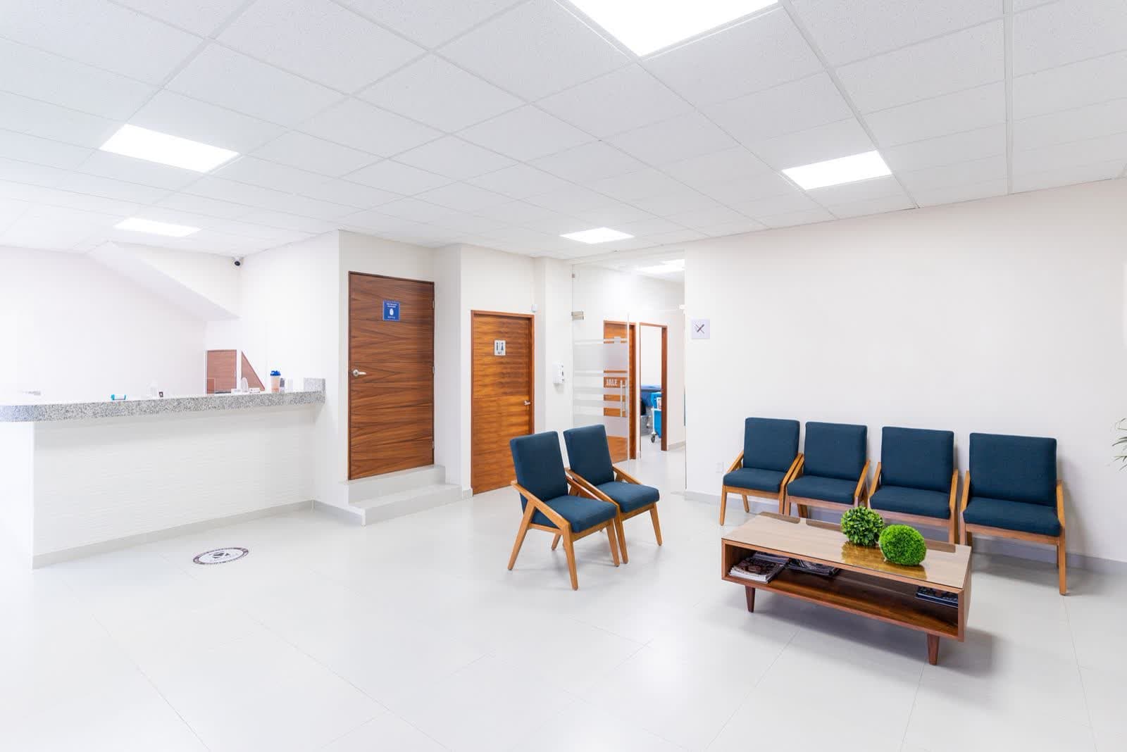 A clean, modern clinic waiting area with empty chairs