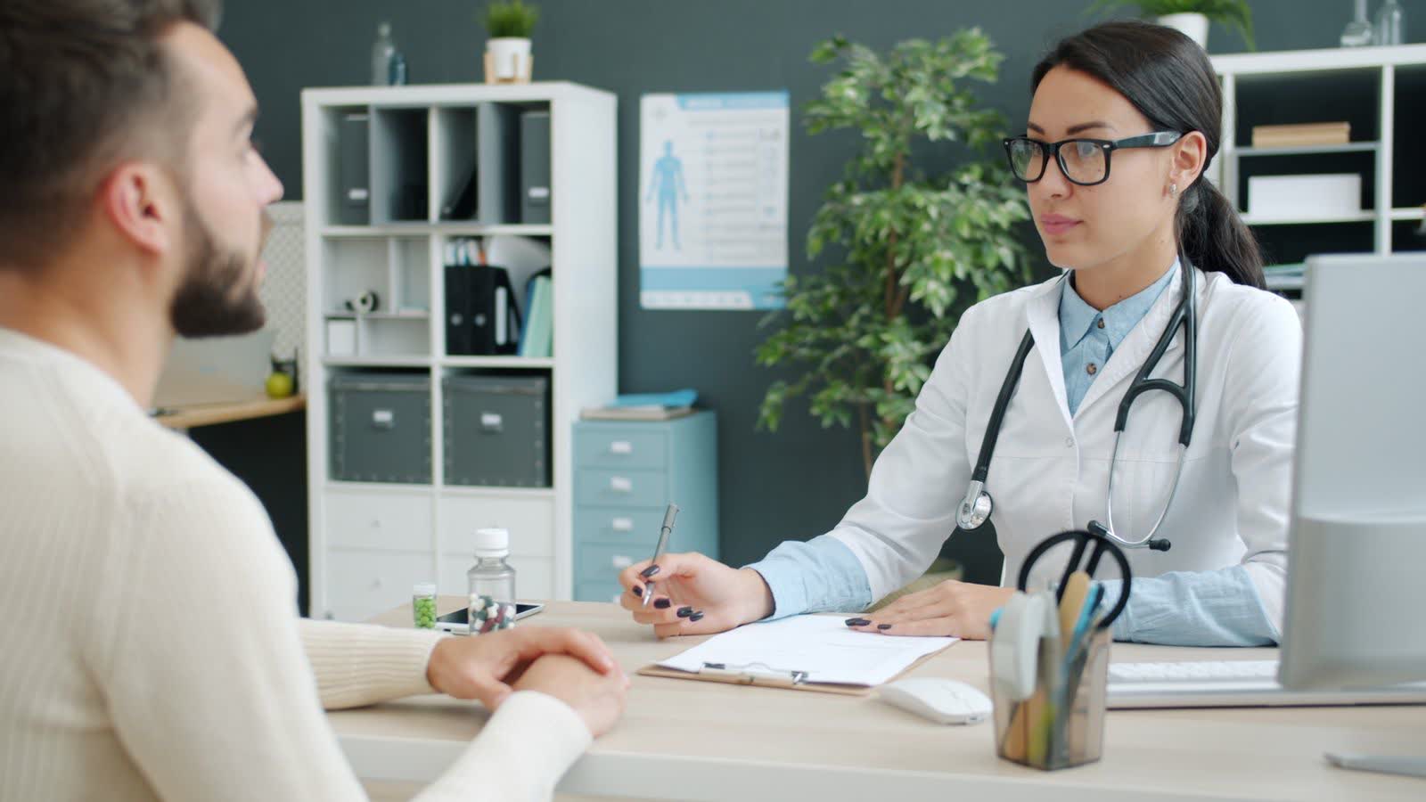 A doctor in consultation with a male patient in a modern clinic office