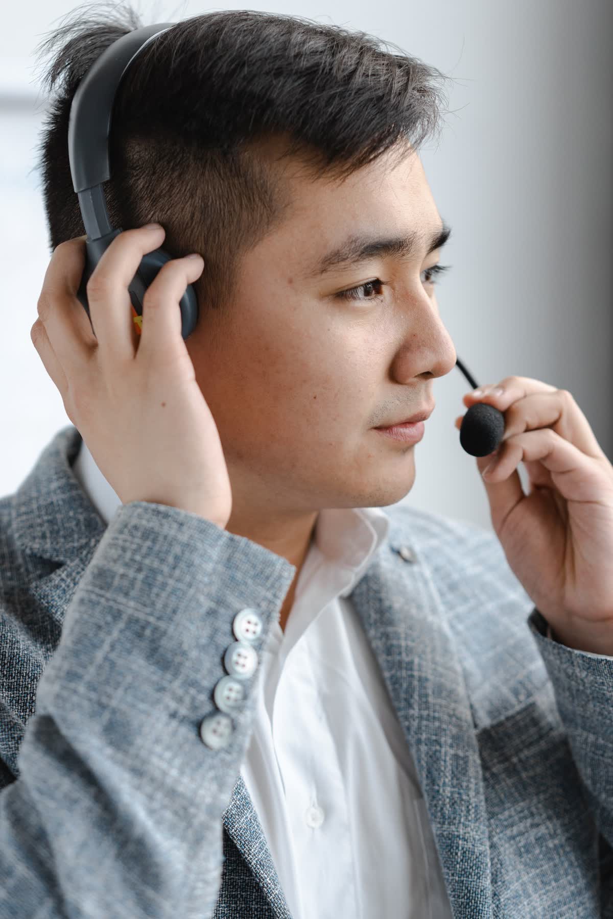 An intake specialist on a live screening call wearing a headset