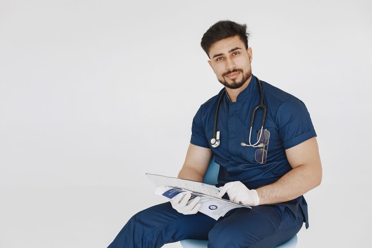 A surgeon in navy scrubs reviewing patient records